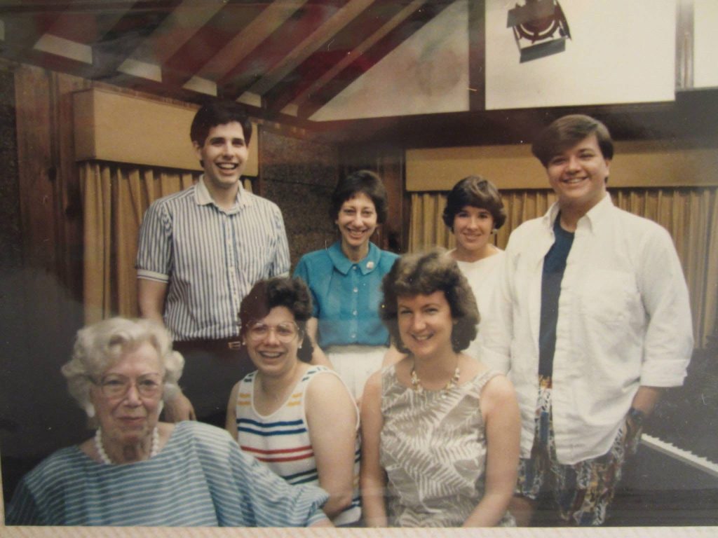 Phyllis Lehrer standing with a group of smiling students and an older colleague in a studio or classroom setting, likely during a music seminar or summer program.