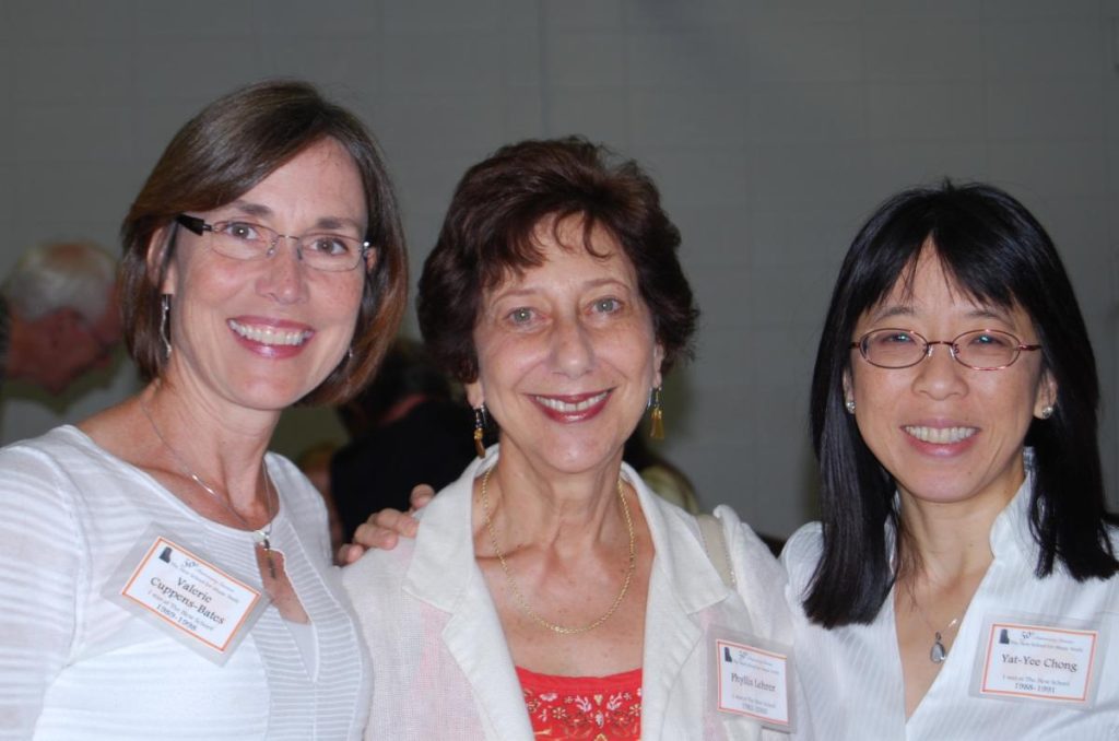 Valerie Cuppens-Bates and Yat-Yee Chong pose for a picture with Phyllis Lehrer against a gray background.