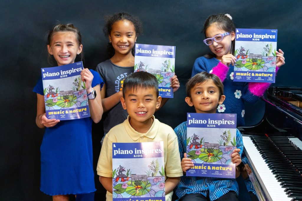 Students pose around a piano with the "Music & Nature" issue of Piano Inspires Kids.