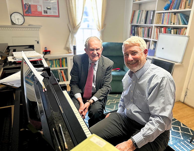 Marvin Blickenstaff photographed at the piano with an adult piano student.